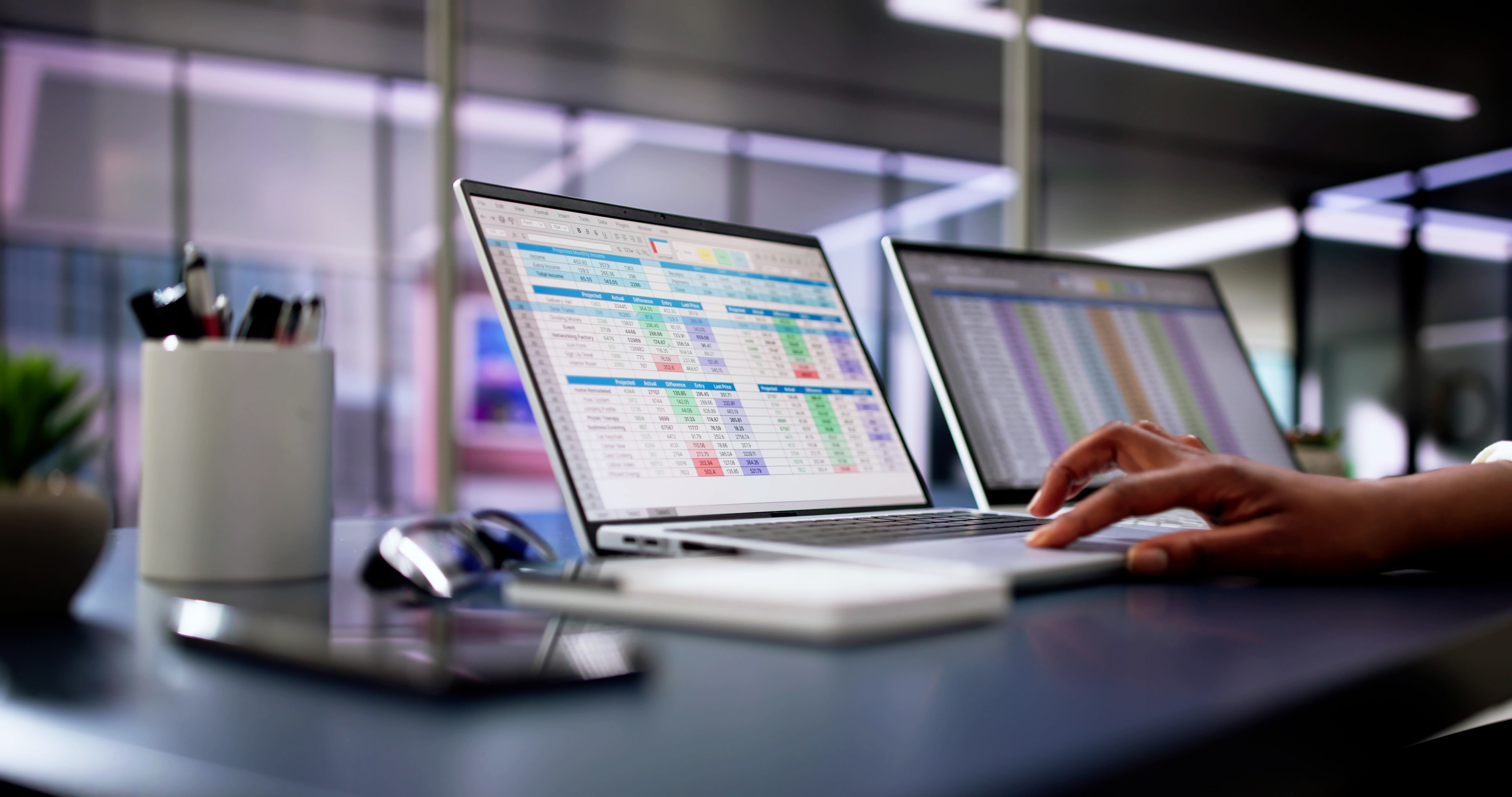 Healthcare professional reviewing data spreadsheets on laptop